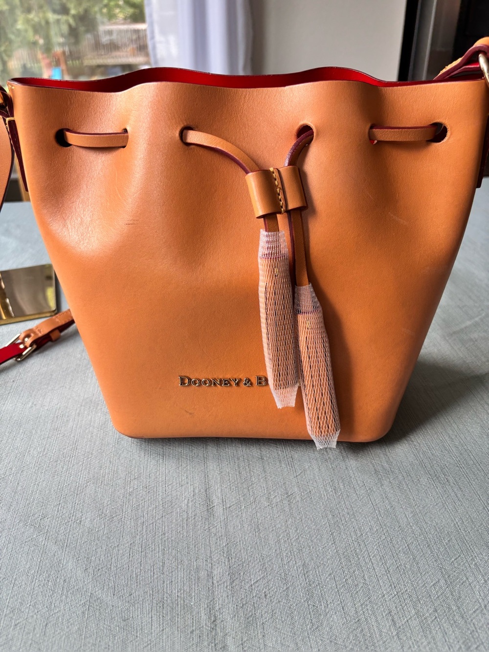 Dooney & Bourke Camel Tan Leather Drawstring Shoulder Bucket Bag with Red Trim